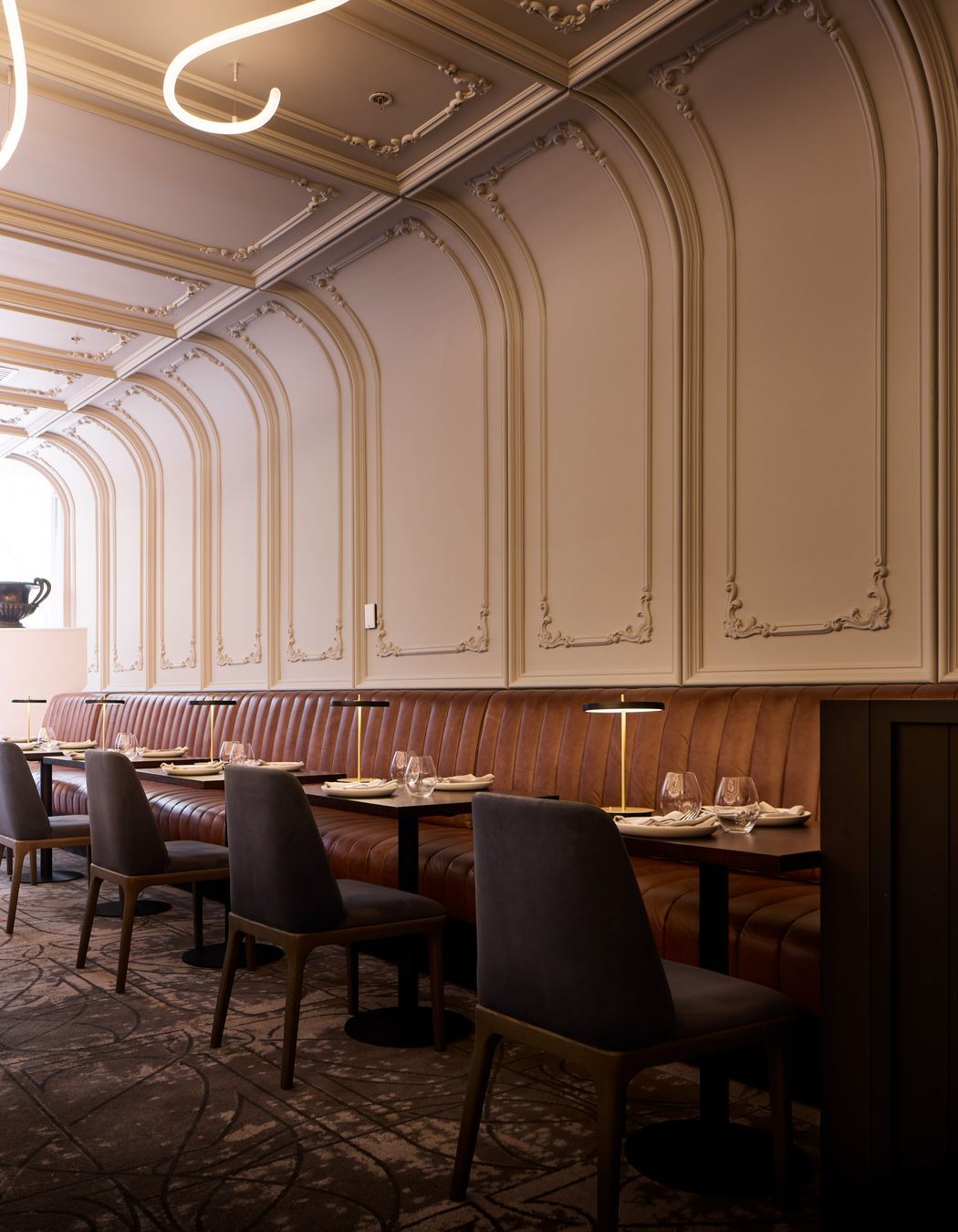 Art Nouveau panelling curves from the wall to the ceiling.