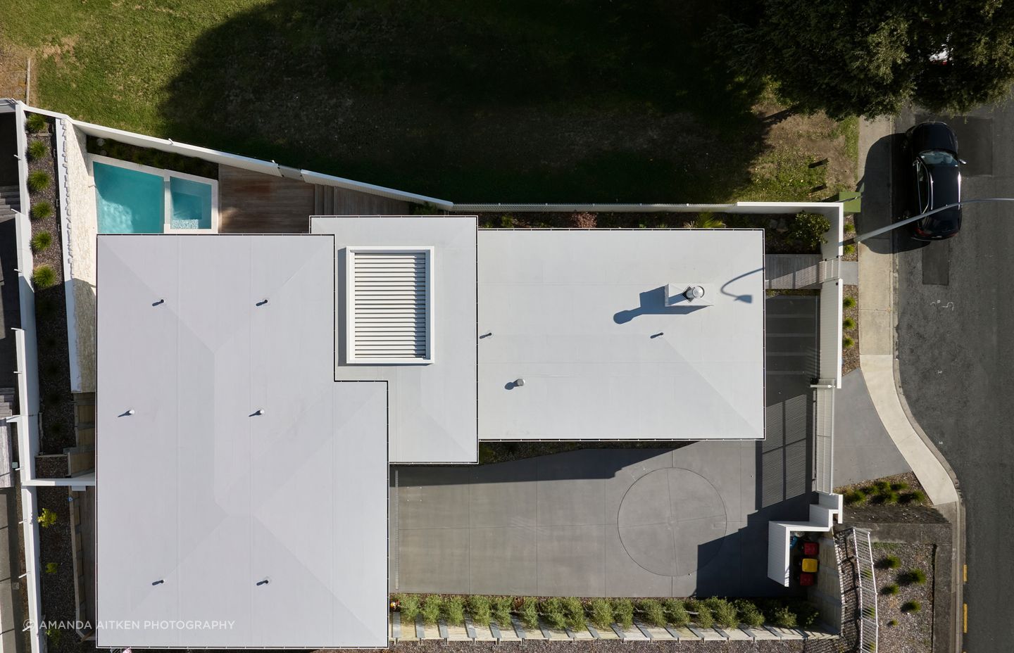 The driveway utilises an onsite vehicle turntable to ease the transition onto the busy street.