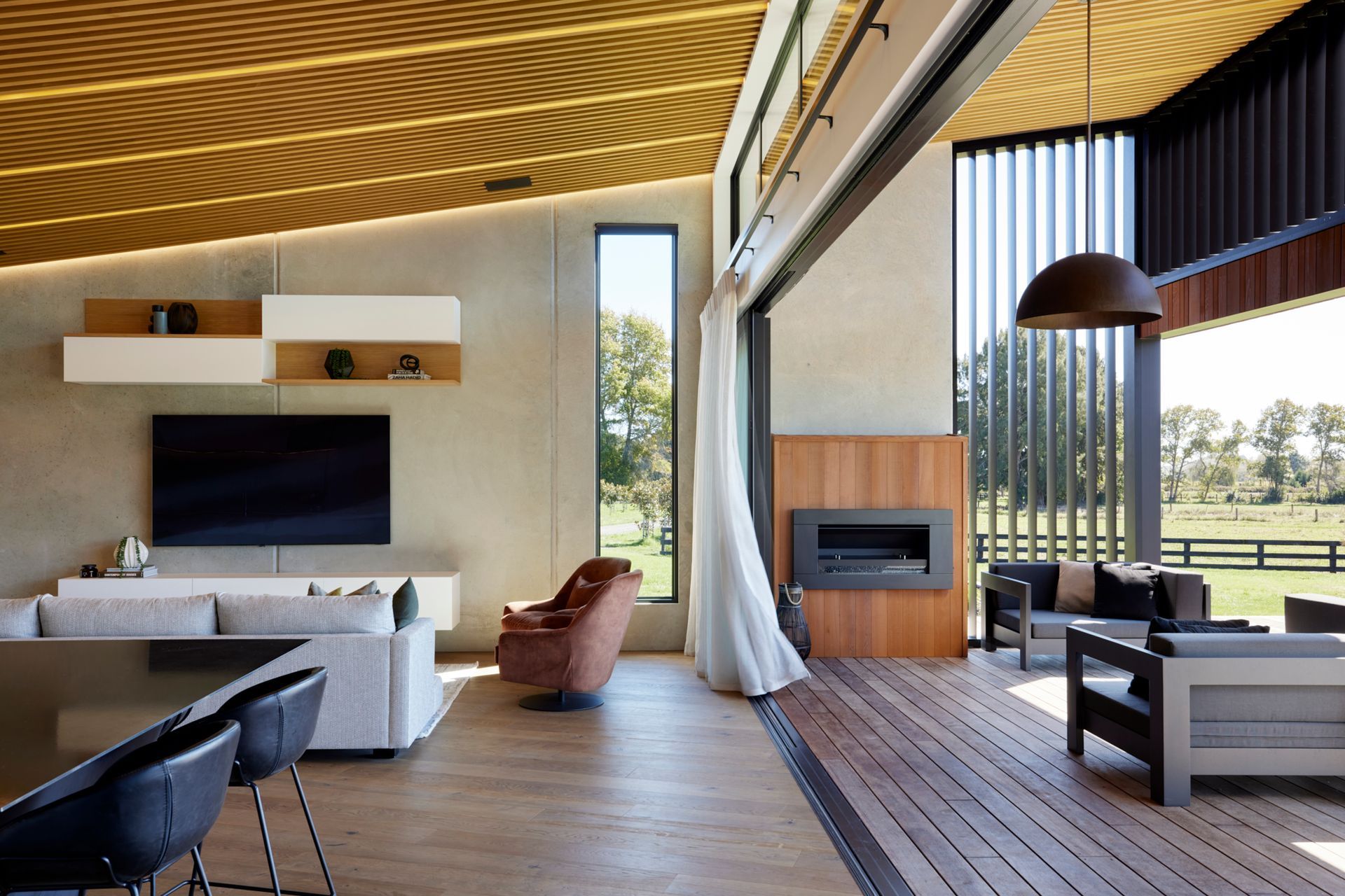 The covered deck area connects seamlessly with the open-plan kitchen, living and dining.