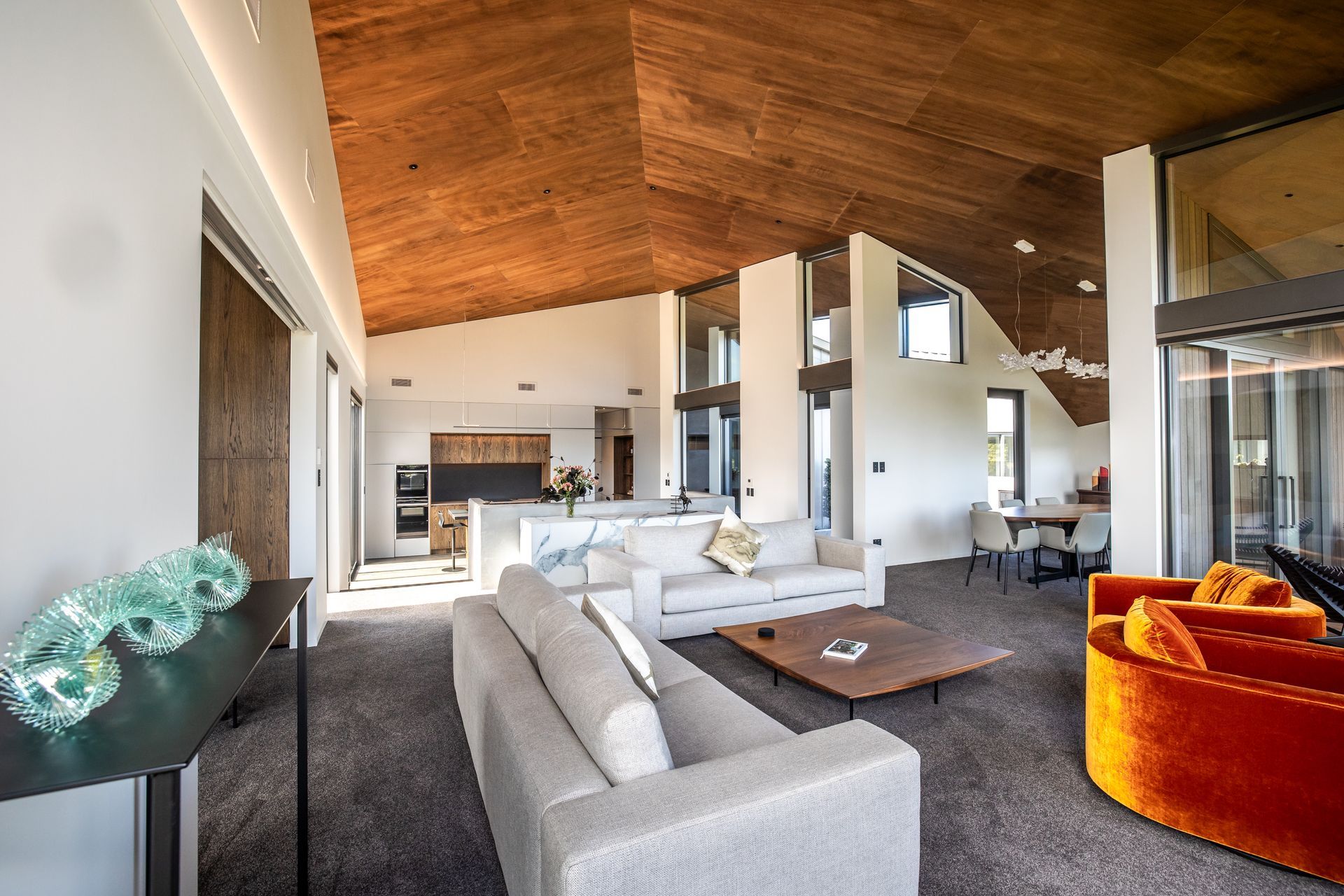 The shape of the interior is dictated by the form of the home, which opens up to the view and closes down towards the road frontage; the stunning timber ply lined ceiling accentuates the dynamic, sculptural form of the home.