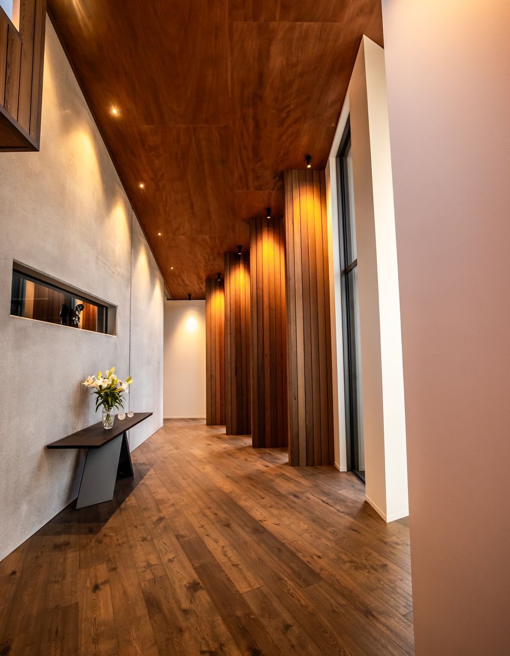 The timber fins in an internal corridor break up the journey to the bedrooms, creating enticing snapshots of the stunning view.