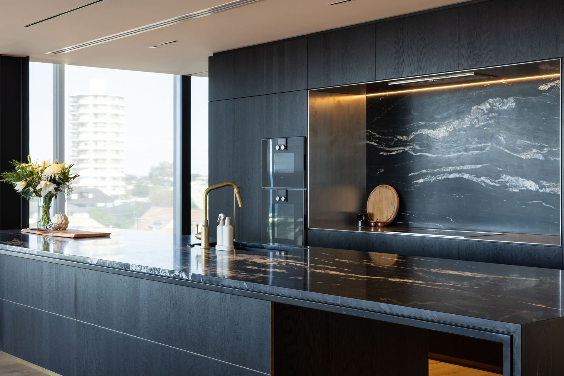 The Milton 110 penthouse makes a bold statement with its dark kitchen.