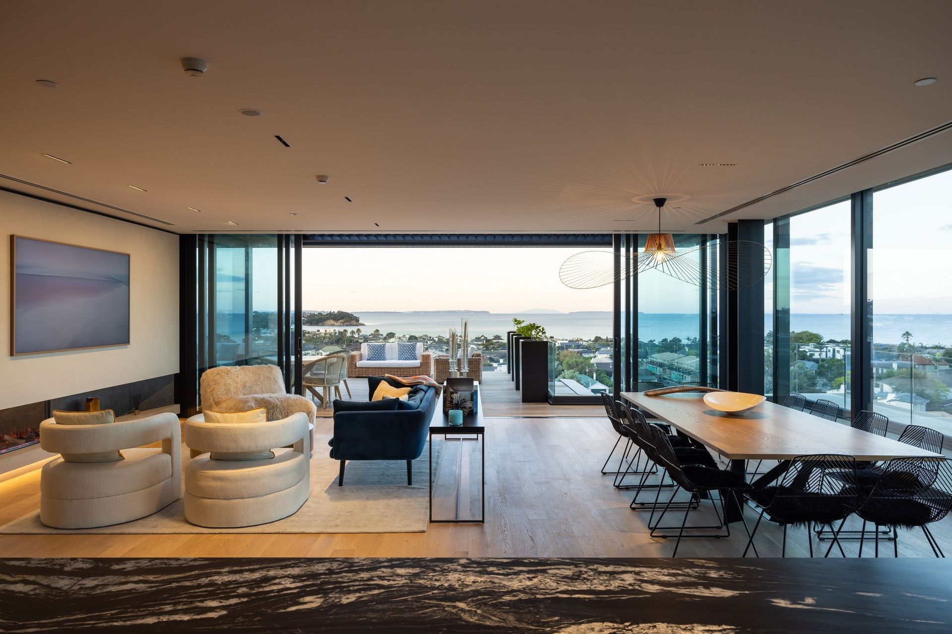 The open-plan kitchen, living and dining area overlooks the water.