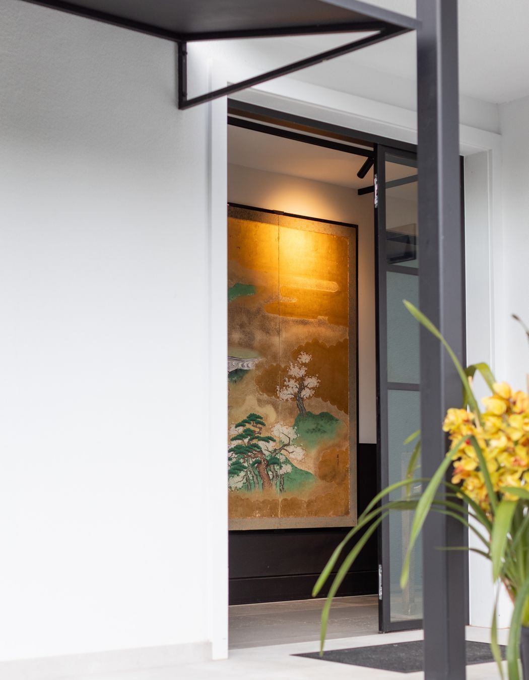 A steel canopy provides shelter in the entrance.