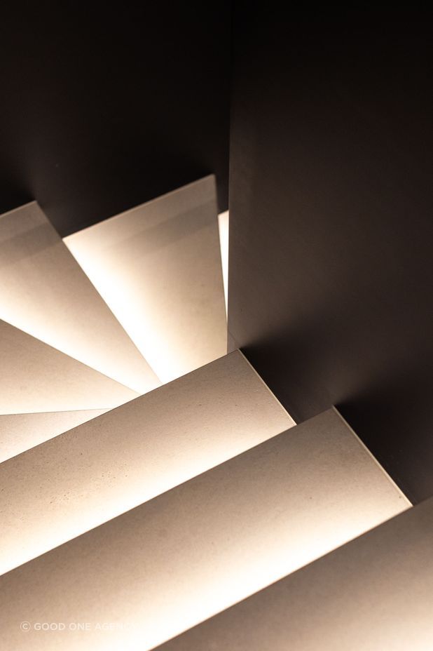 The treads on the steel stairwell are up-lit with LED lighting, creating a sculptural effect.