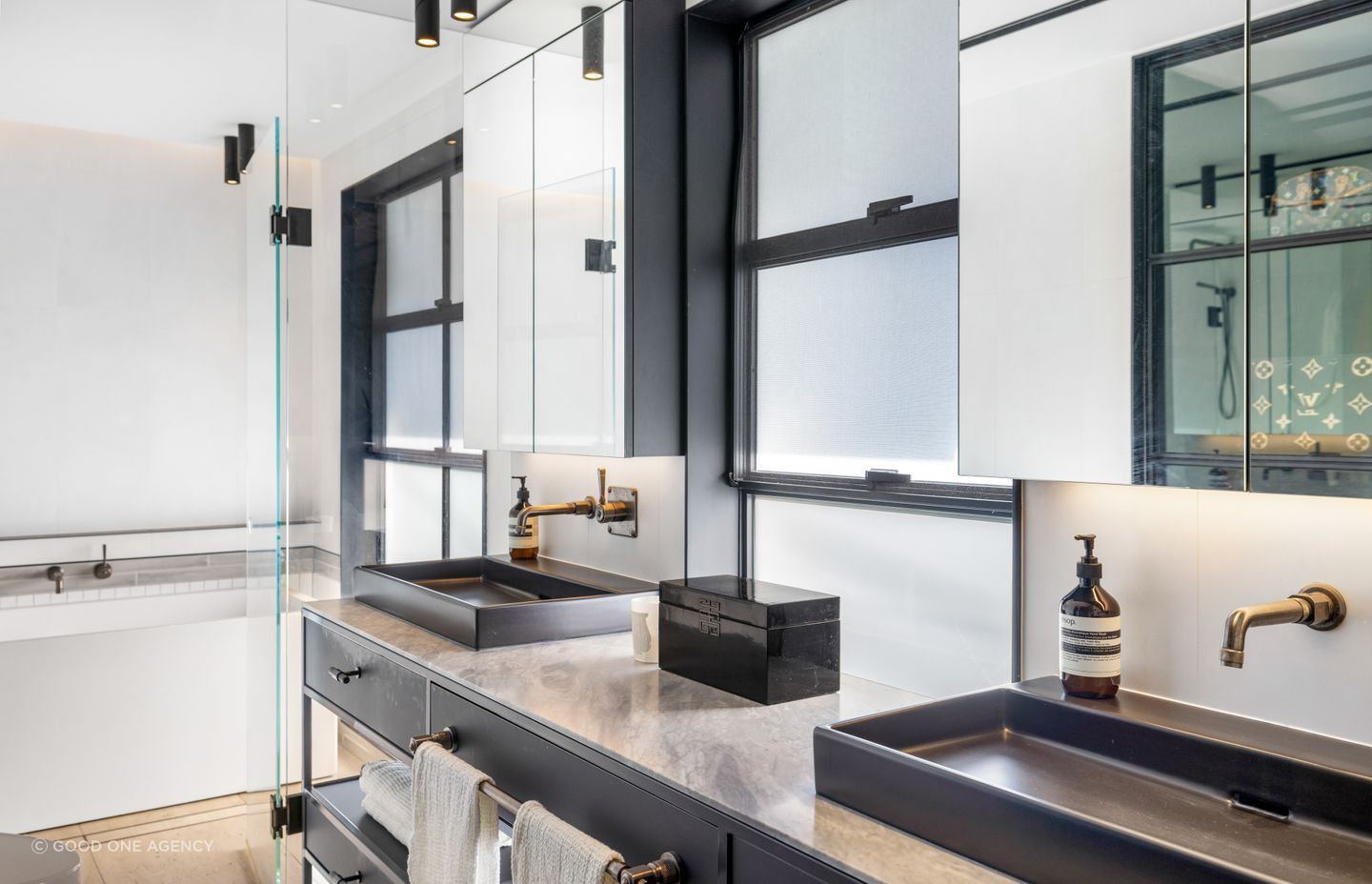 Steel and glass elements create a sleek look in the master ensuite.