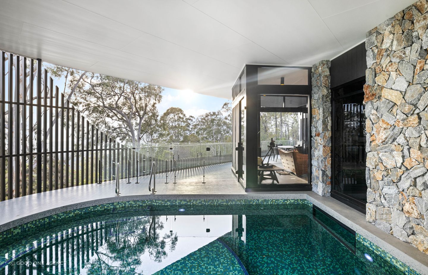 The aluminium batten facade is cut away on one side to reveal the view.