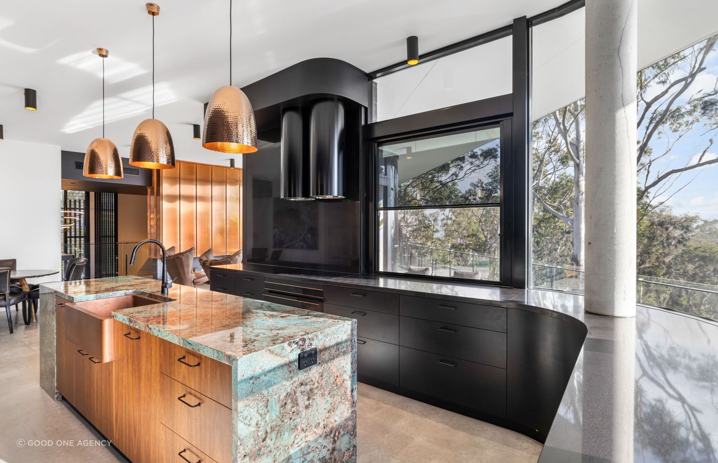 The green tones of the central island's Amazonite benchtop draw in the hues in nature.