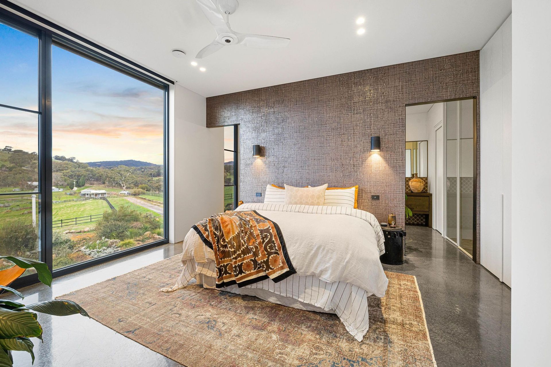 The guest room in the guest wing at Euroa House is layered and cosy