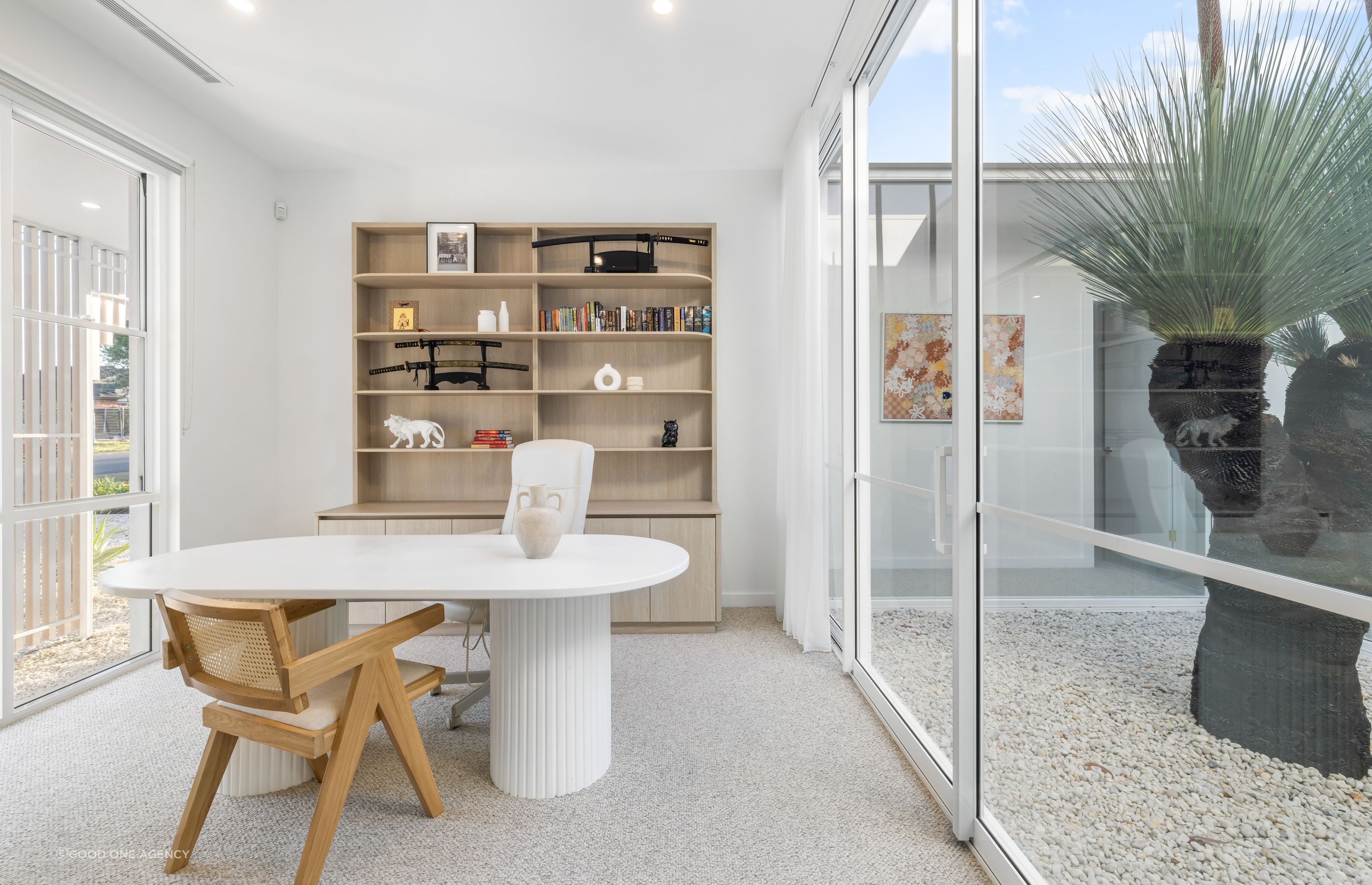 The study near the front of the house takes its light from an internal courtyard, enjoying a view of the grass tree.