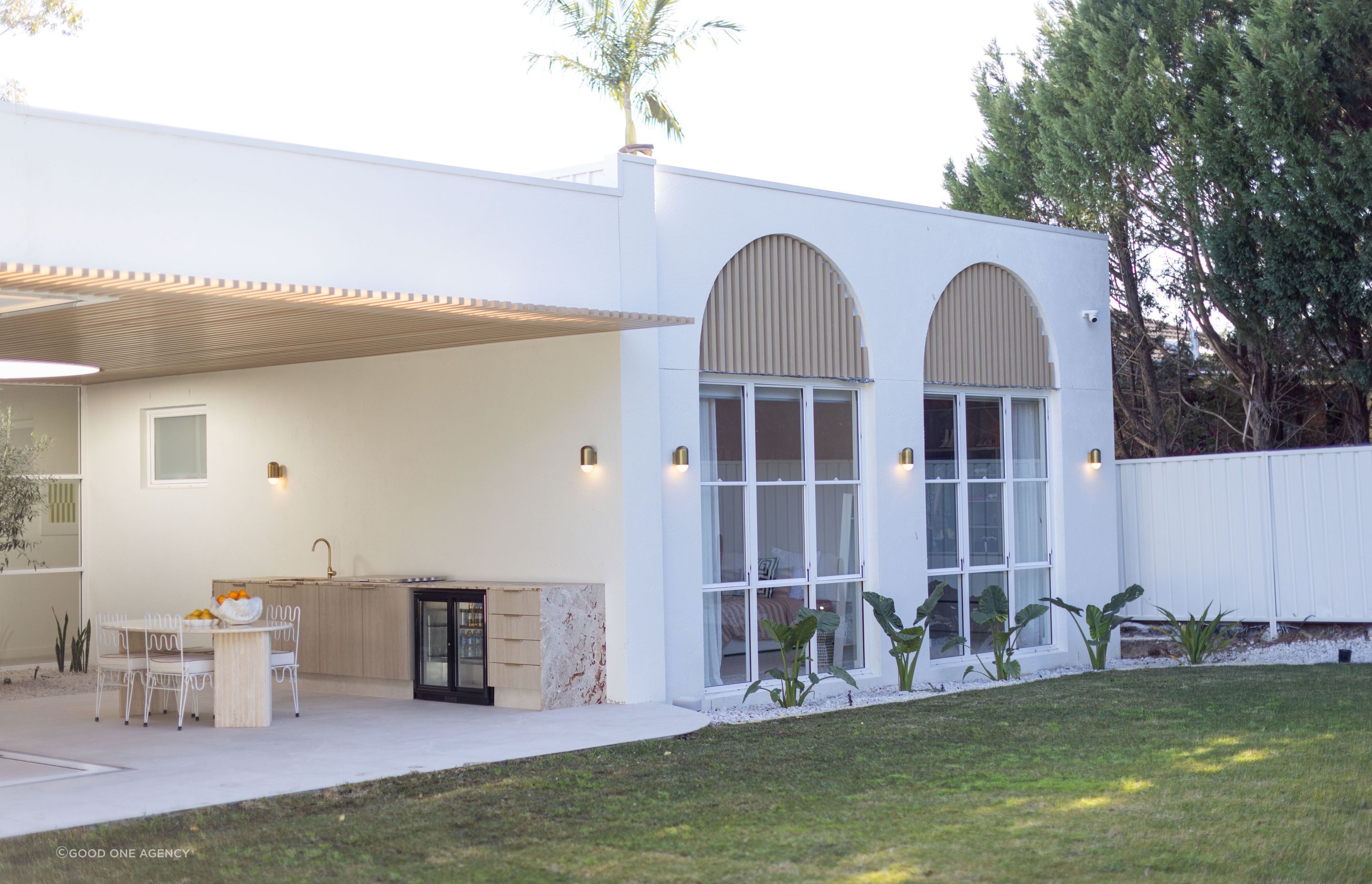 The exterior at the back of the home celebrates the arches found in Mediterranean architecture, while remaining contemporary in style.