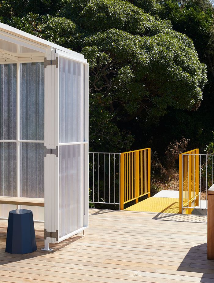 The yellow metal bridge provides access to the roof deck.