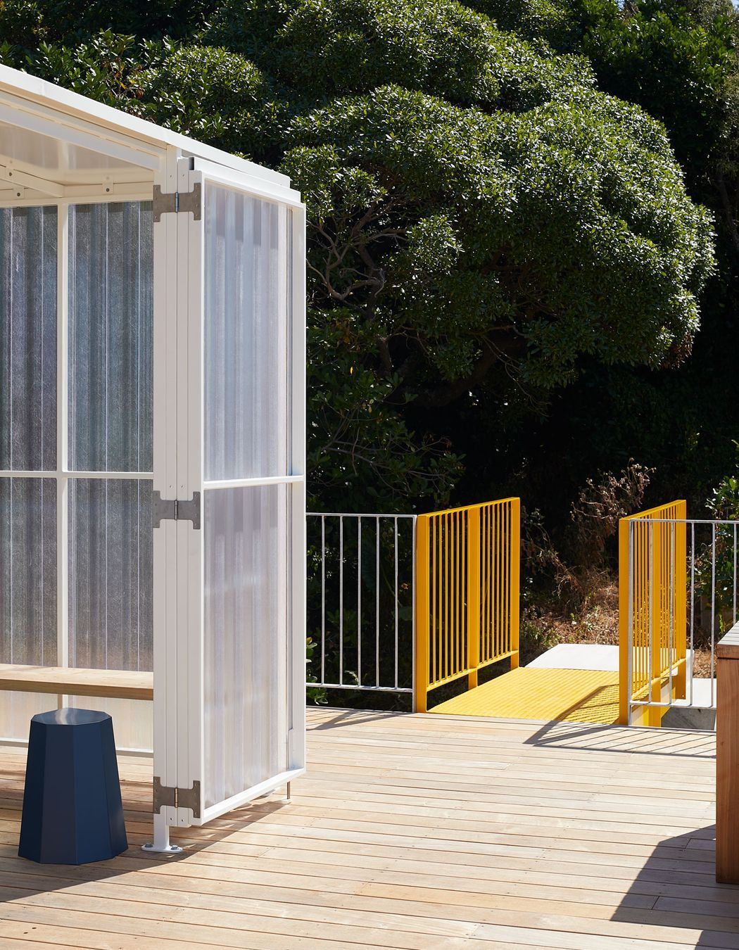 The yellow metal bridge provides access to the roof deck.