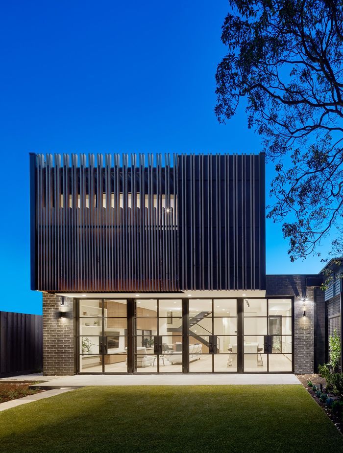 The timber slats speak to the interior materiality of the extension and complete the visual identity of the home's rear.