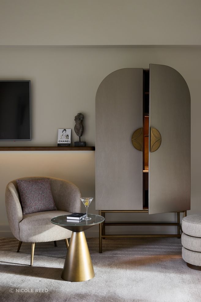 Custom Art Nouveau cabinetry conceals the minibar.