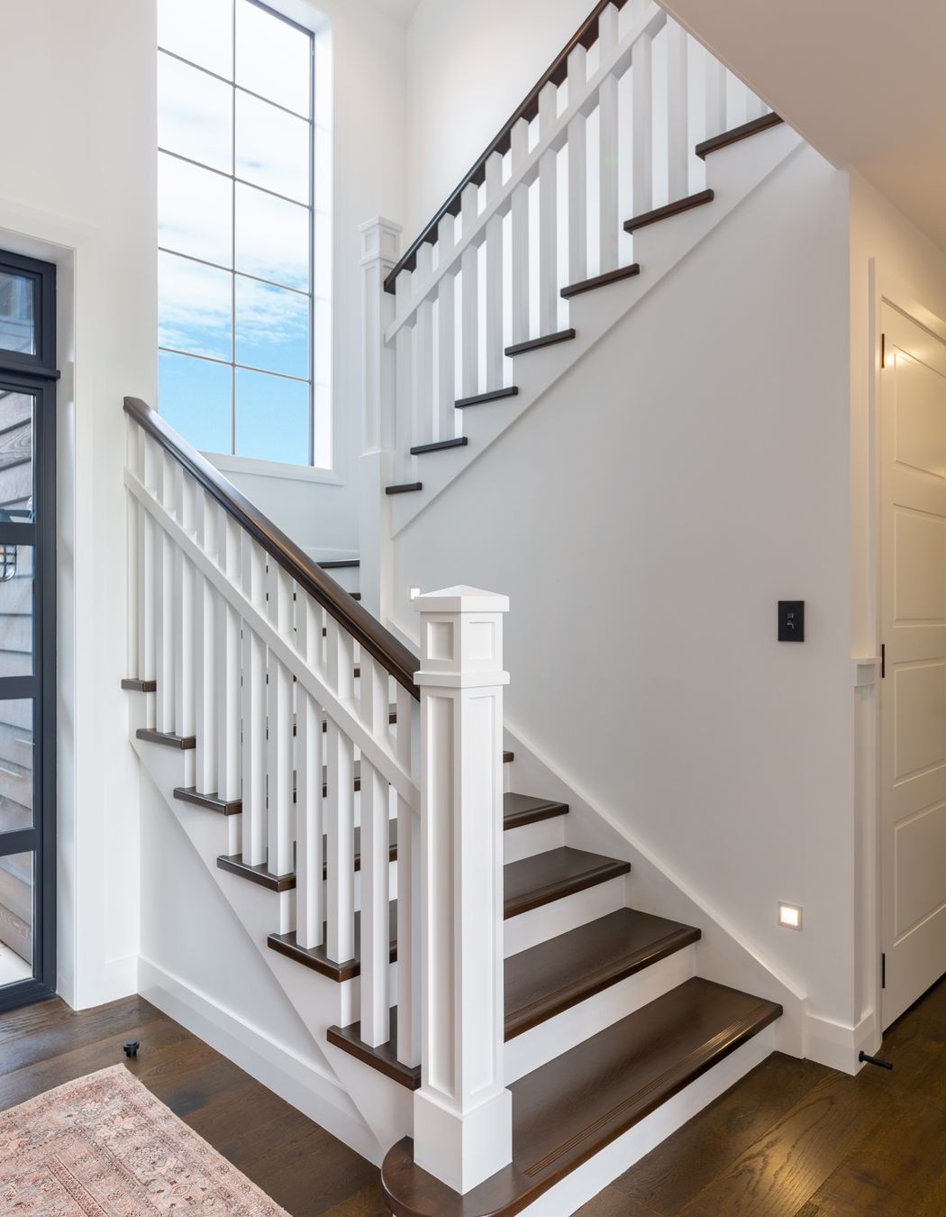 The stunning staircase with traditional newell post detail and oak treads is a beauty to behold, and fits in seamlessly with the engineered timber floors and character detailing.