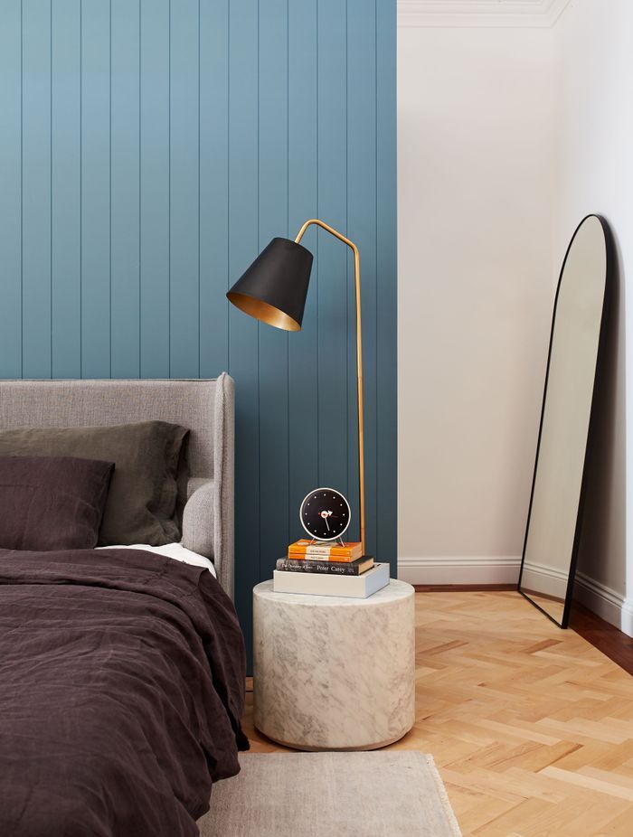 The wall behind the bed divides the room from the walk-in wardrobe behind it.