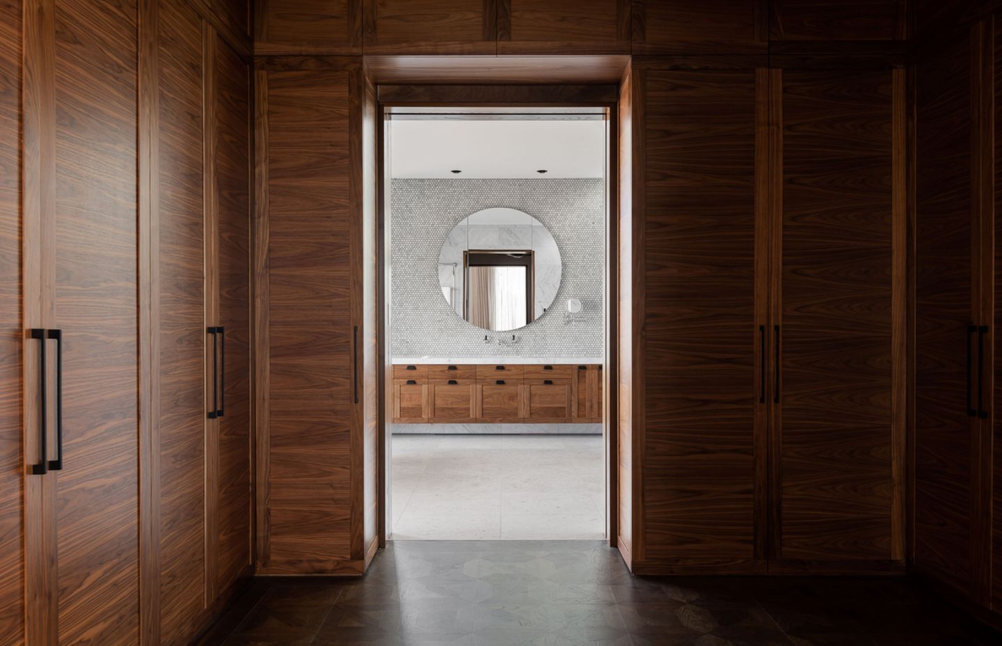 Solid walnut cabinetry and panelling features throughout, cut from full pieces so that the grain continues fluidly from one piece to the next.