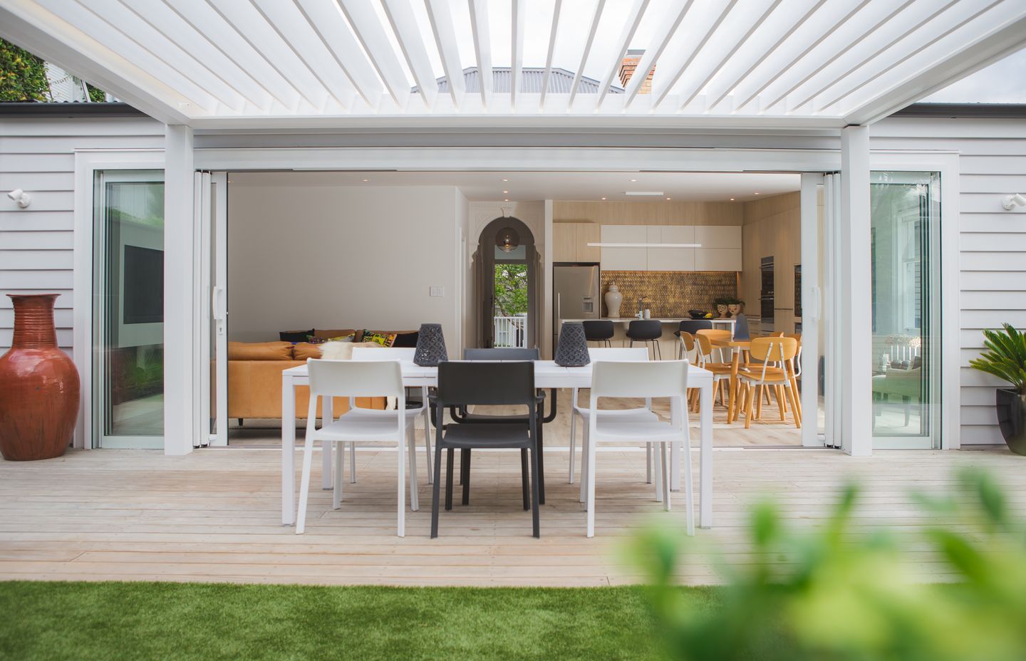 An extension to the interior living space, the outdoor entertaining area is shaded from a louvre system.