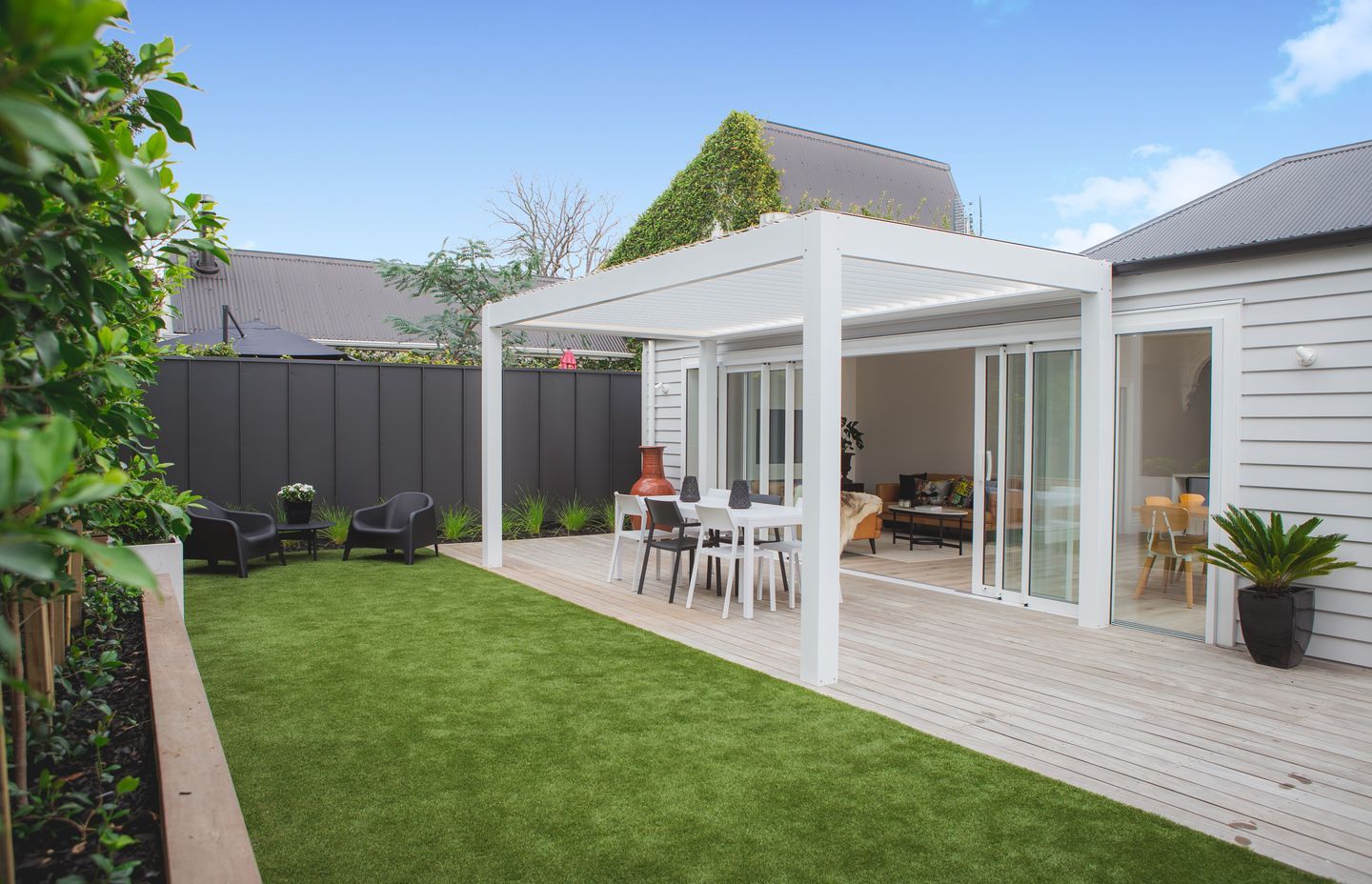 The deck and grass are at the same level to provide a seamless transition between the two.