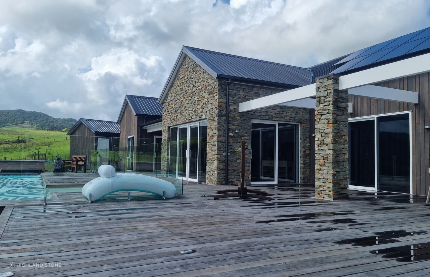 Alternating with dark-stained timber cladding, the stone walls add charm and personality to the sprawling single-story home.