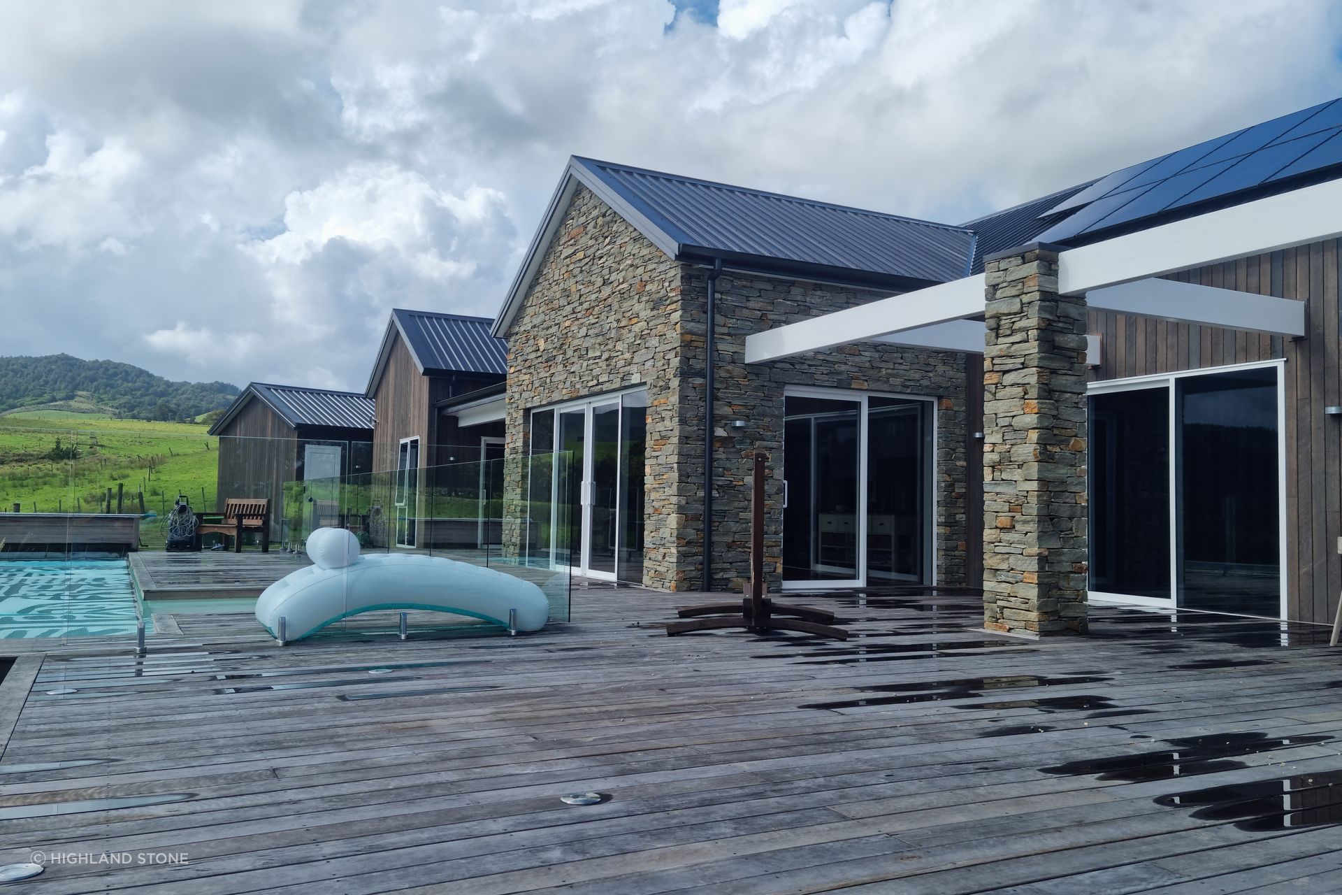 Alternating with dark-stained timber cladding, the stone walls add charm and personality to the sprawling single-story home.