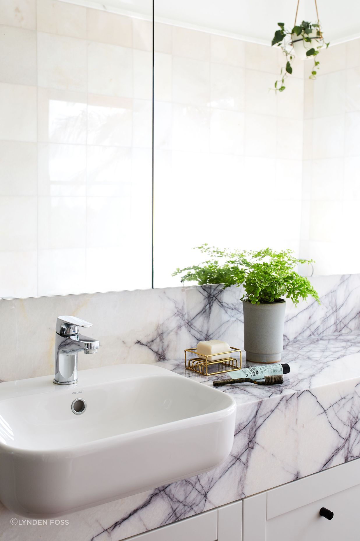 The master ensuite is modern yet tactile with a stone counter top.