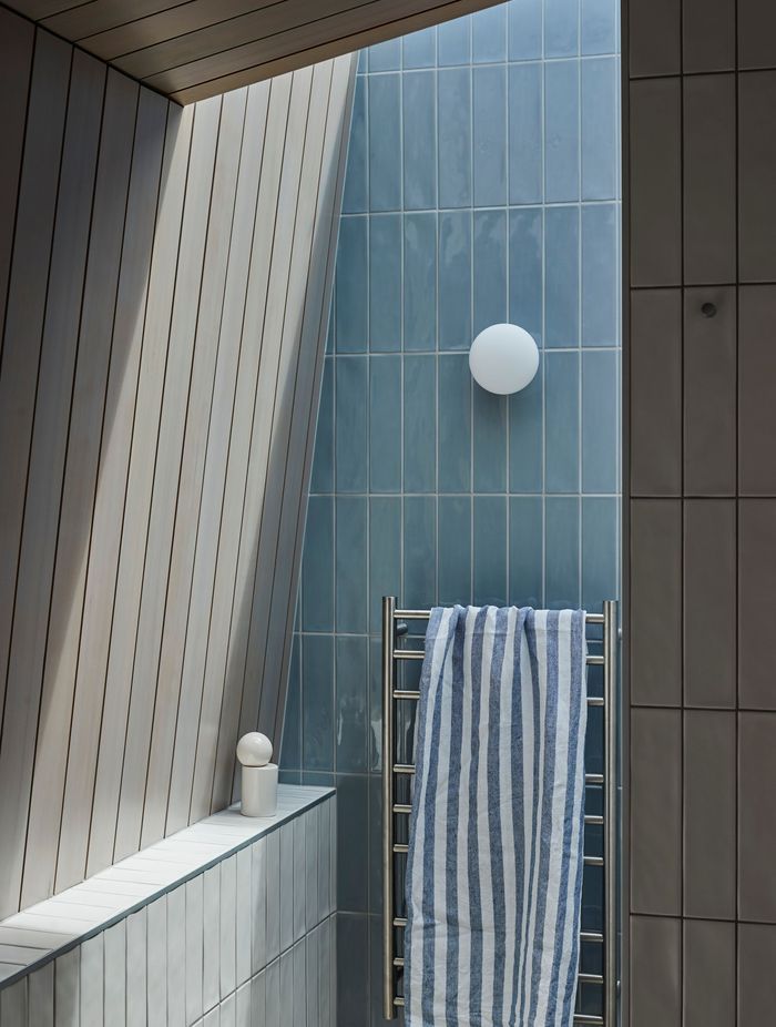 The entry to the shower in the master suite's bathroom, bathed in sun from the overhead skylight. | Photographer: Jackie Meiring