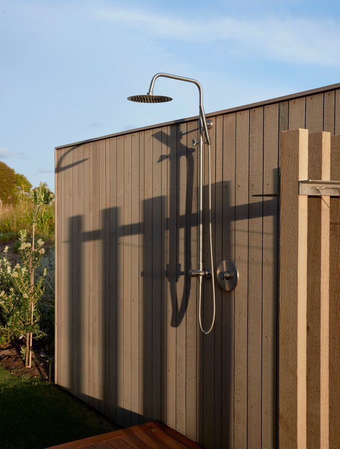 The outdoor shower, sheltered by a cedar-clad fence. | Photographer: Jackie Meiring