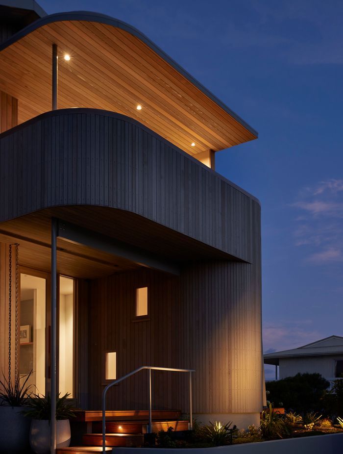 The cedar-clad and curved entry to Tent House. | Photographer: Jackie Meiring