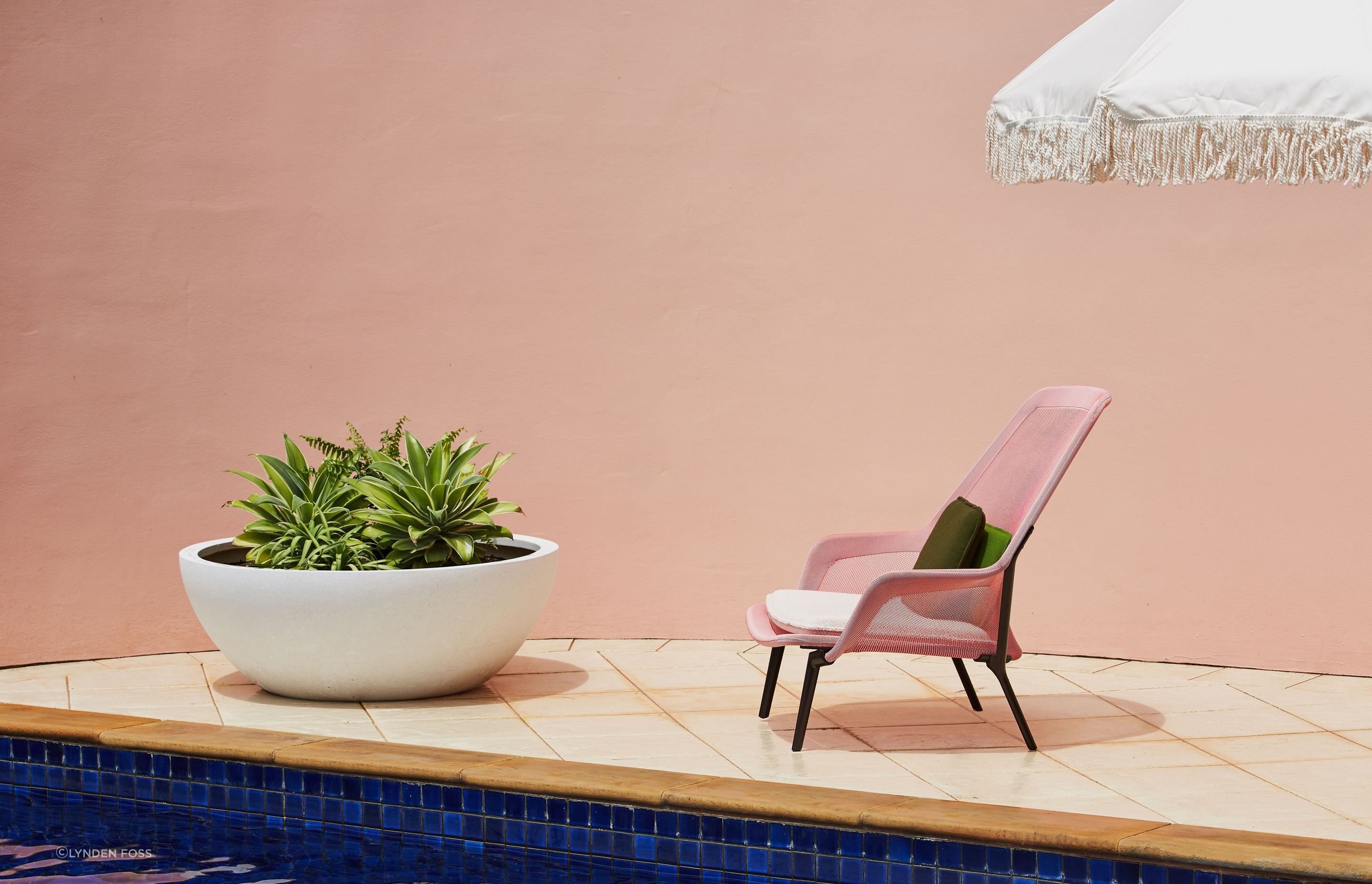The wall wrapping around the outdoor spaces was painted in a soft dirty pink and gives off a real holiday vibe.