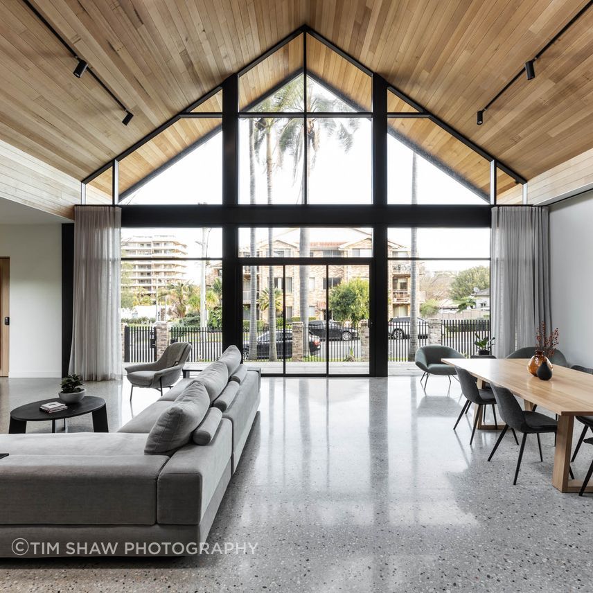 Polished concrete floors balance the warm timber ceiling.