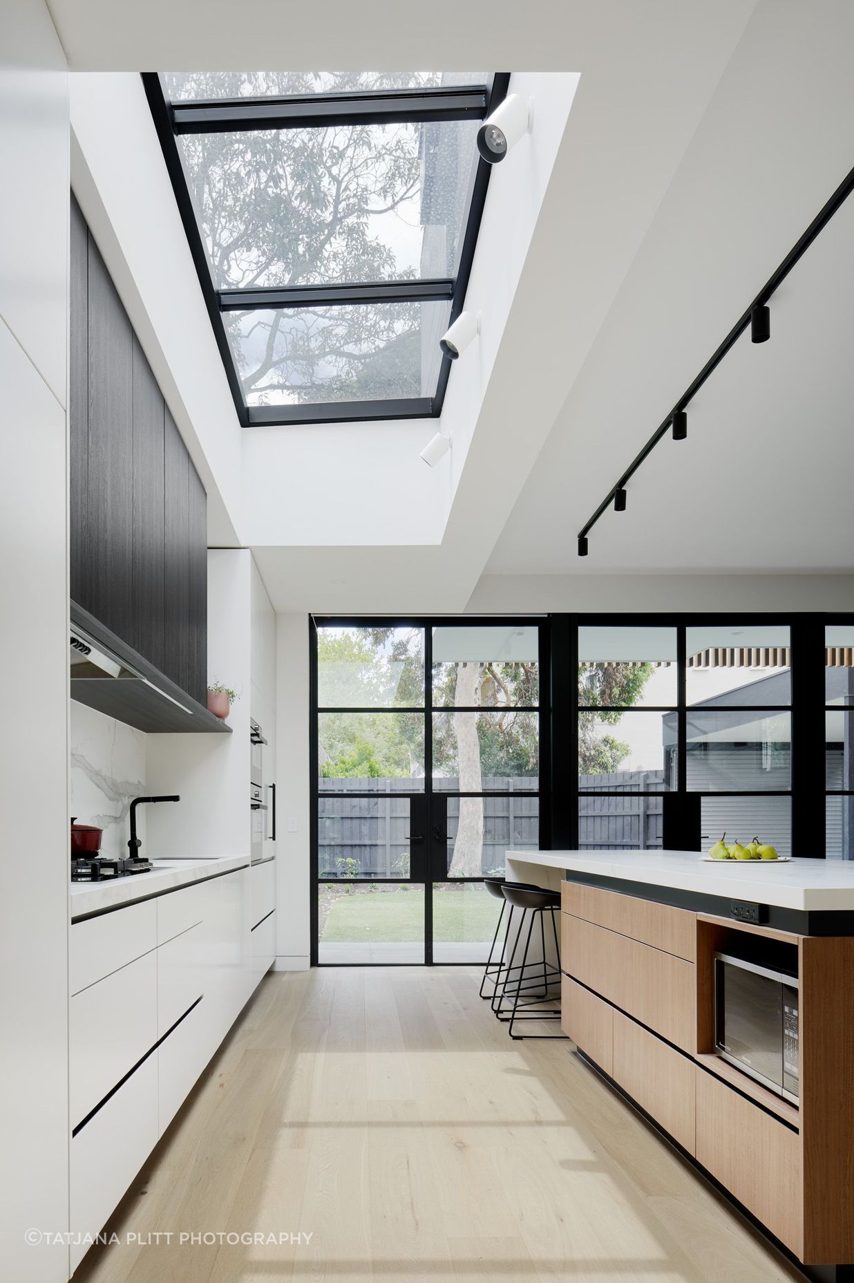 A skylight allows natural light to flow into the kitchen.