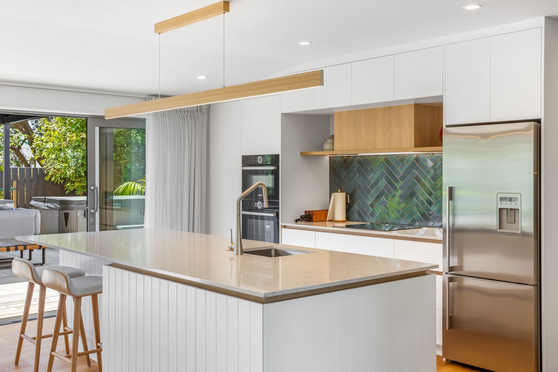The luxury kitchen finishes and fully tiled bathroom make the clients feel as if they have checked into a hotel — “It’s a completely different house!”