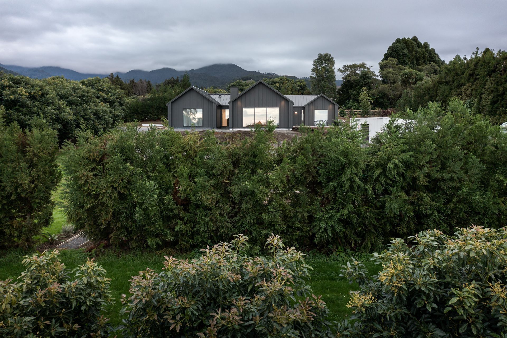 Perched overlooking the orchard, the colour of the home helps it to blend with the surrounds.