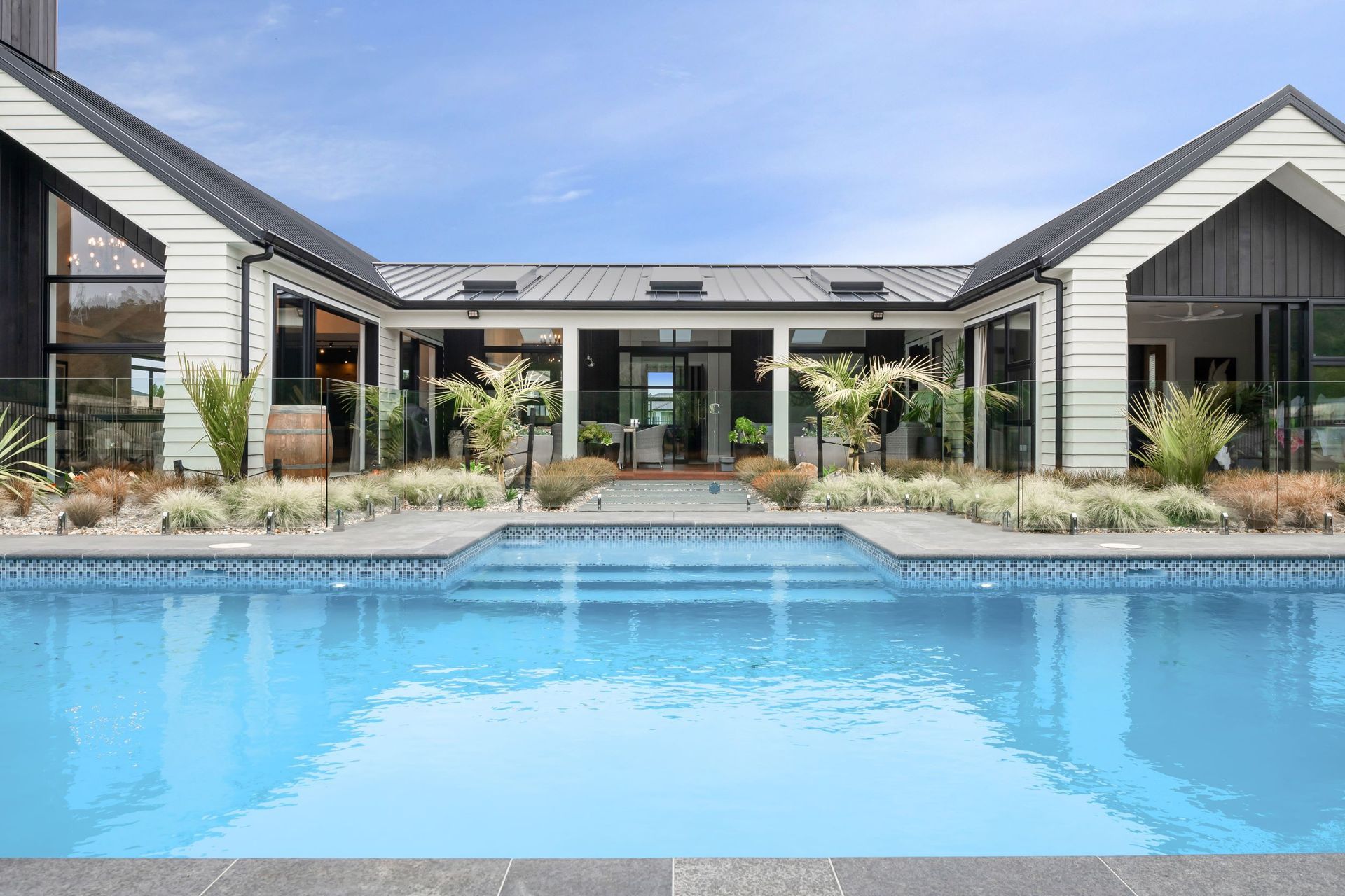 A lavish and luxurrious swimming pool is one of many highlights in this outdoor living space. | Photography: Danilo Dijamco