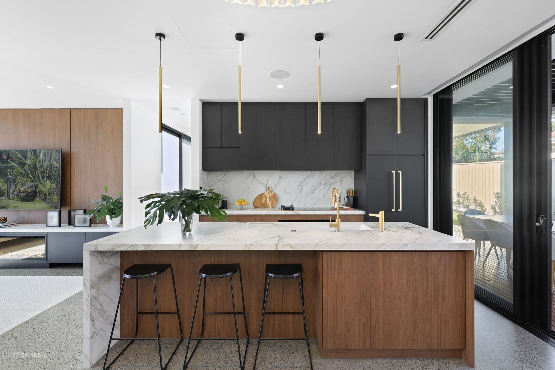 A matching backsplash and island bench featuring sublime Grande Max Golden White slabs in this open plan design at Feilberg Place - Photography: DIB CHIDIAC