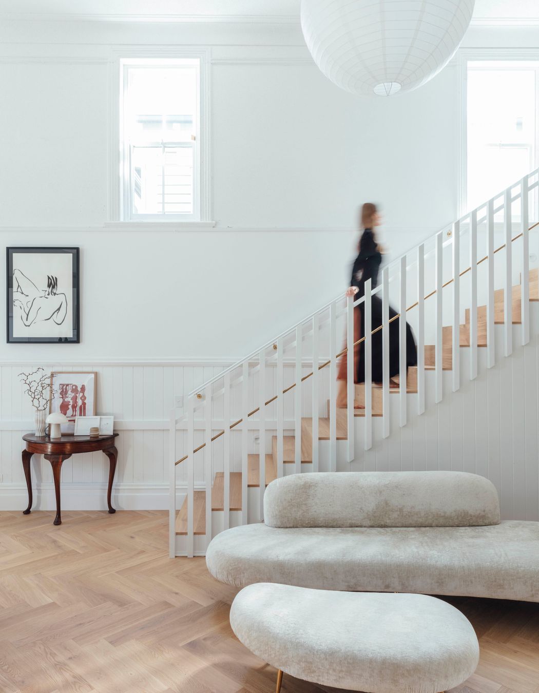 A timber screen marks the stairs leading up to the primary bedroom in the northwestern corner of the main hall.