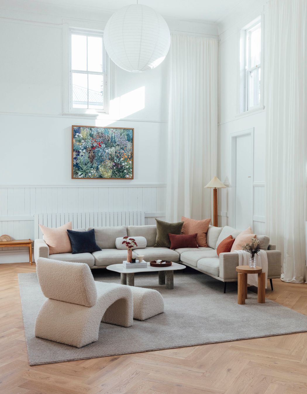 Swathes of clean, white paint cover walls to reflect natural light, softened by the warmth of herringbone oak flooring and restored original brickwork.