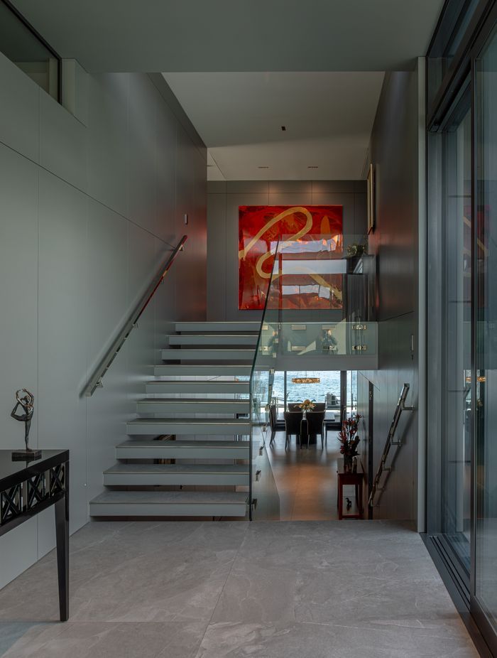 In the foyer, staircases seem to float, and bannisters glow, backlit by LED lights.