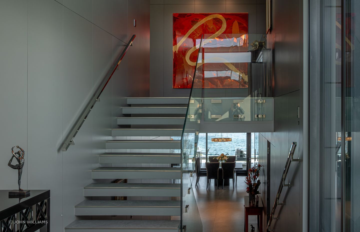 In the foyer, staircases seem to float, and bannisters glow, backlit by LED lights.