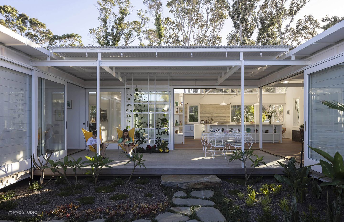 Large sliding doors seamlessly connect the indoor and outdoor living spaces.