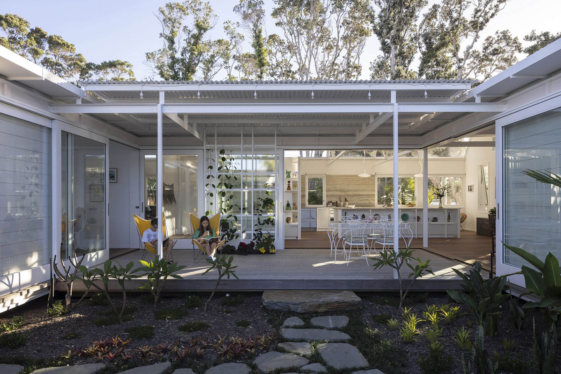 Large sliding doors seamlessly connect the indoor and outdoor living spaces.