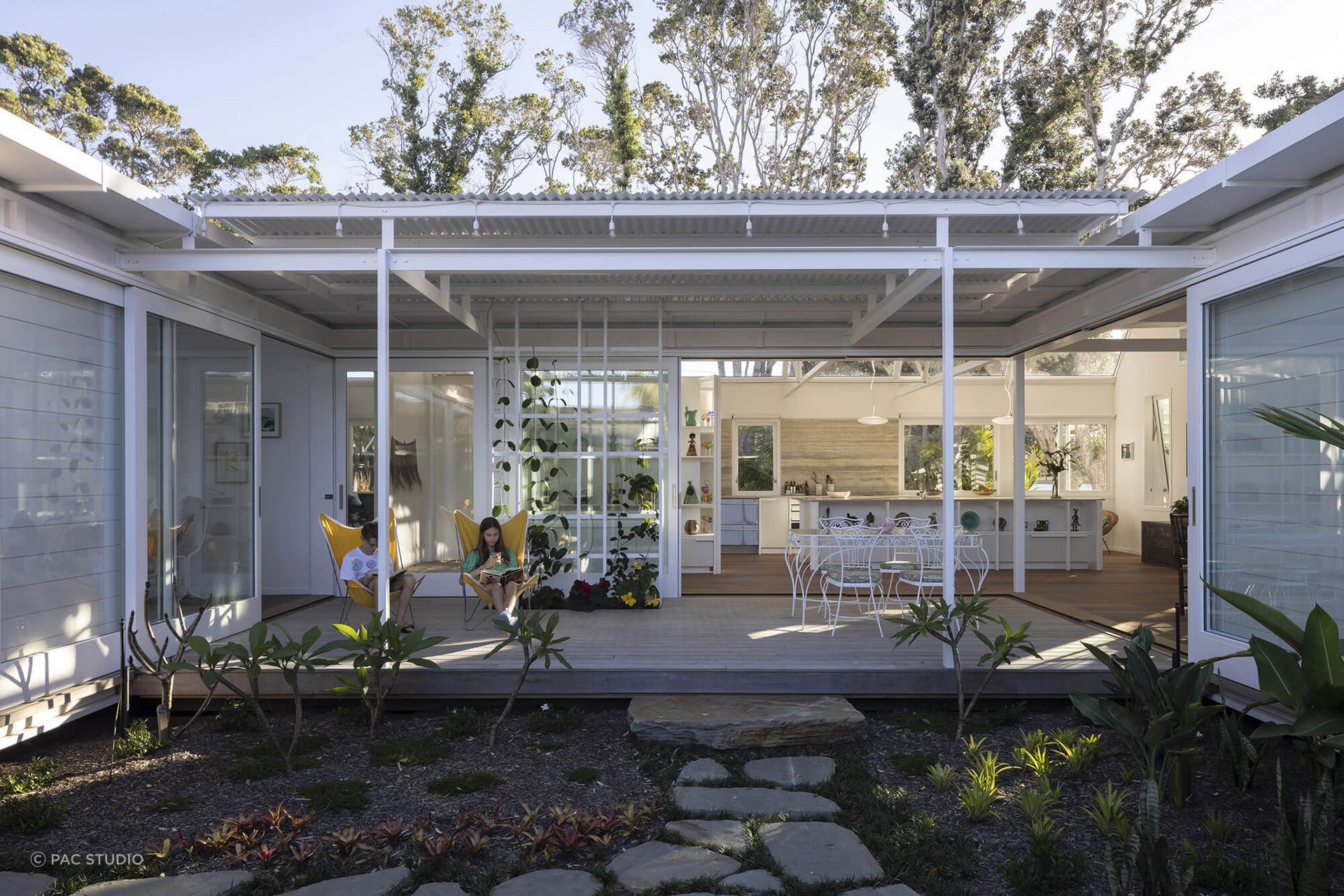 Large sliding doors seamlessly connect the indoor and outdoor living spaces.
