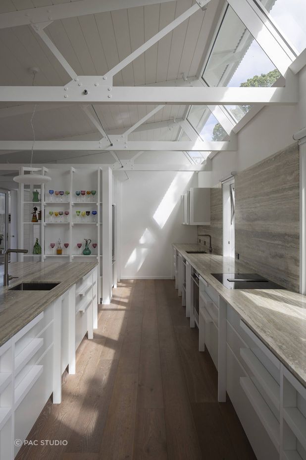 From sunrise to sunset, light is invited into the interior spaces, resulting in a warm, bright living environment.