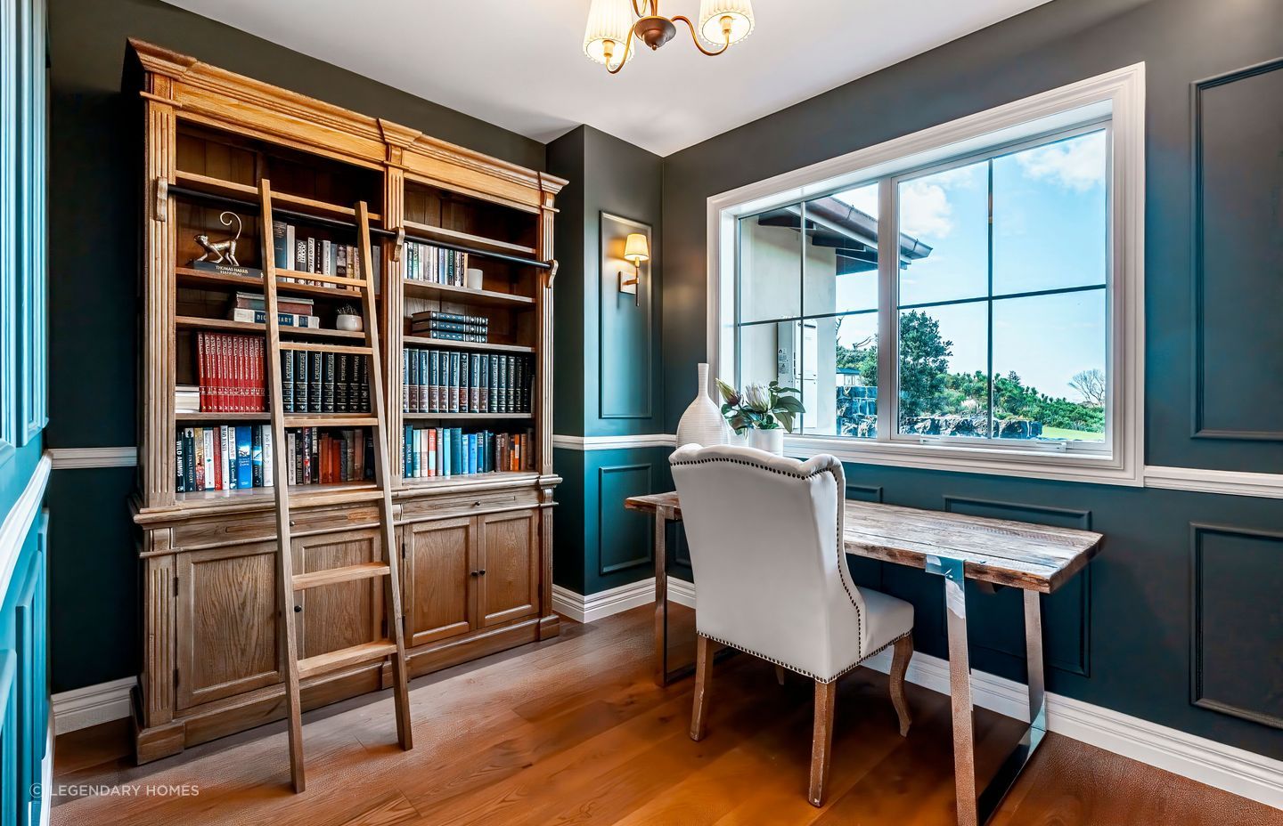 With dark walls and a beautiful bookshelf with ladder access, the study space has become a favourite part of the home.