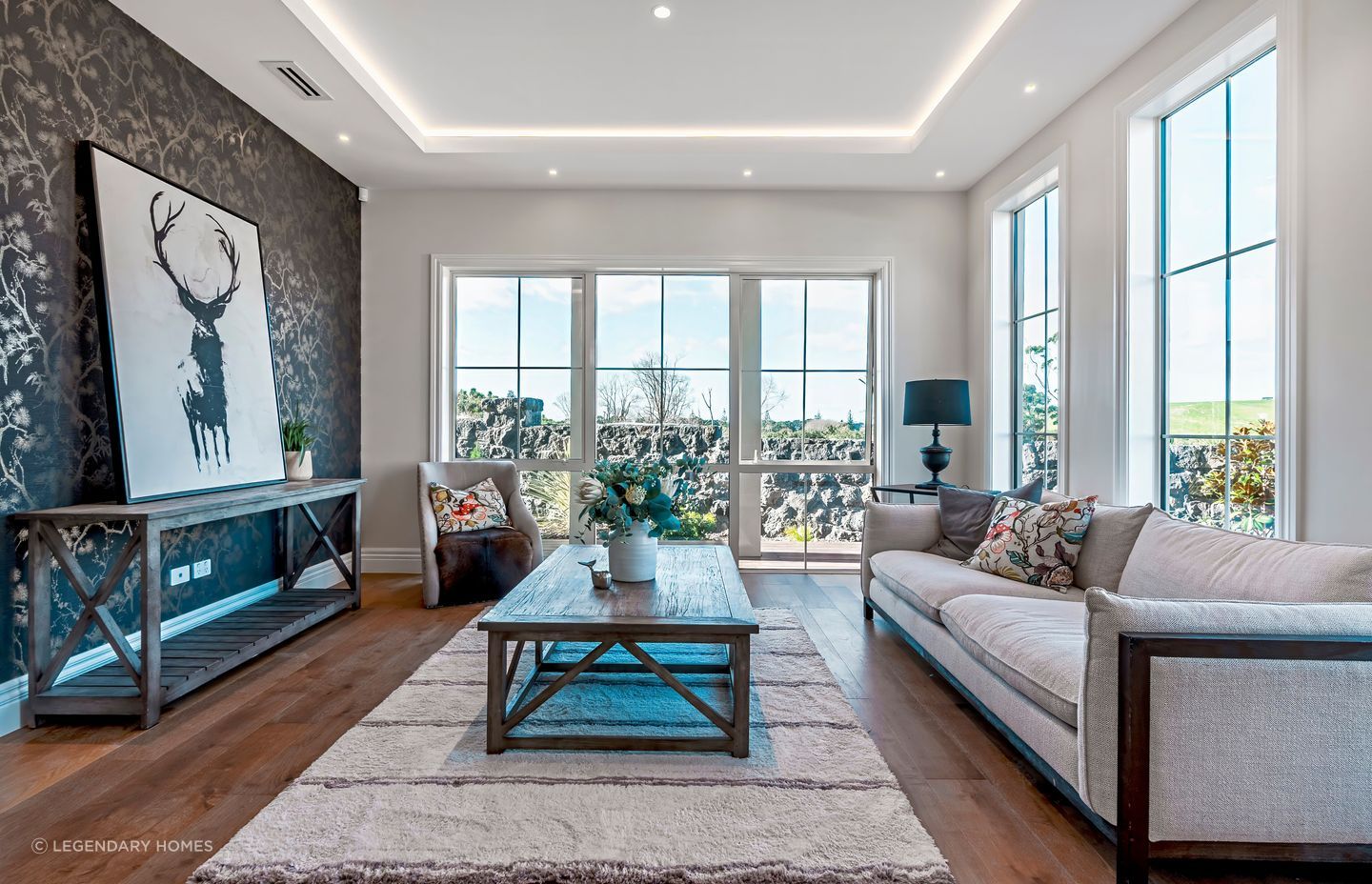 Natural light enters the sitting room. At night, the recessed ceiling lights create a relaxed atmosphere.