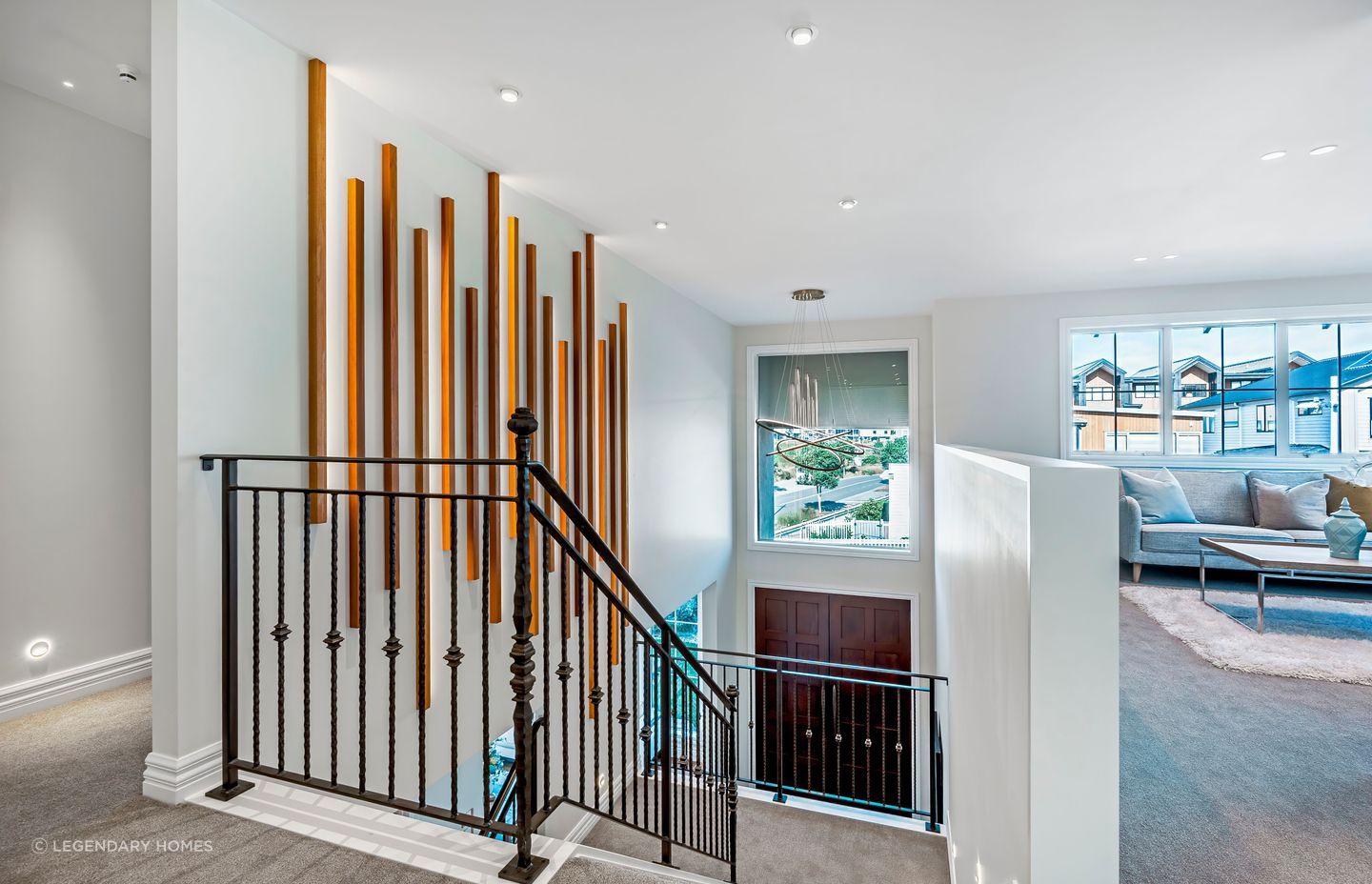 The staircase features an ornate iron balustrade.