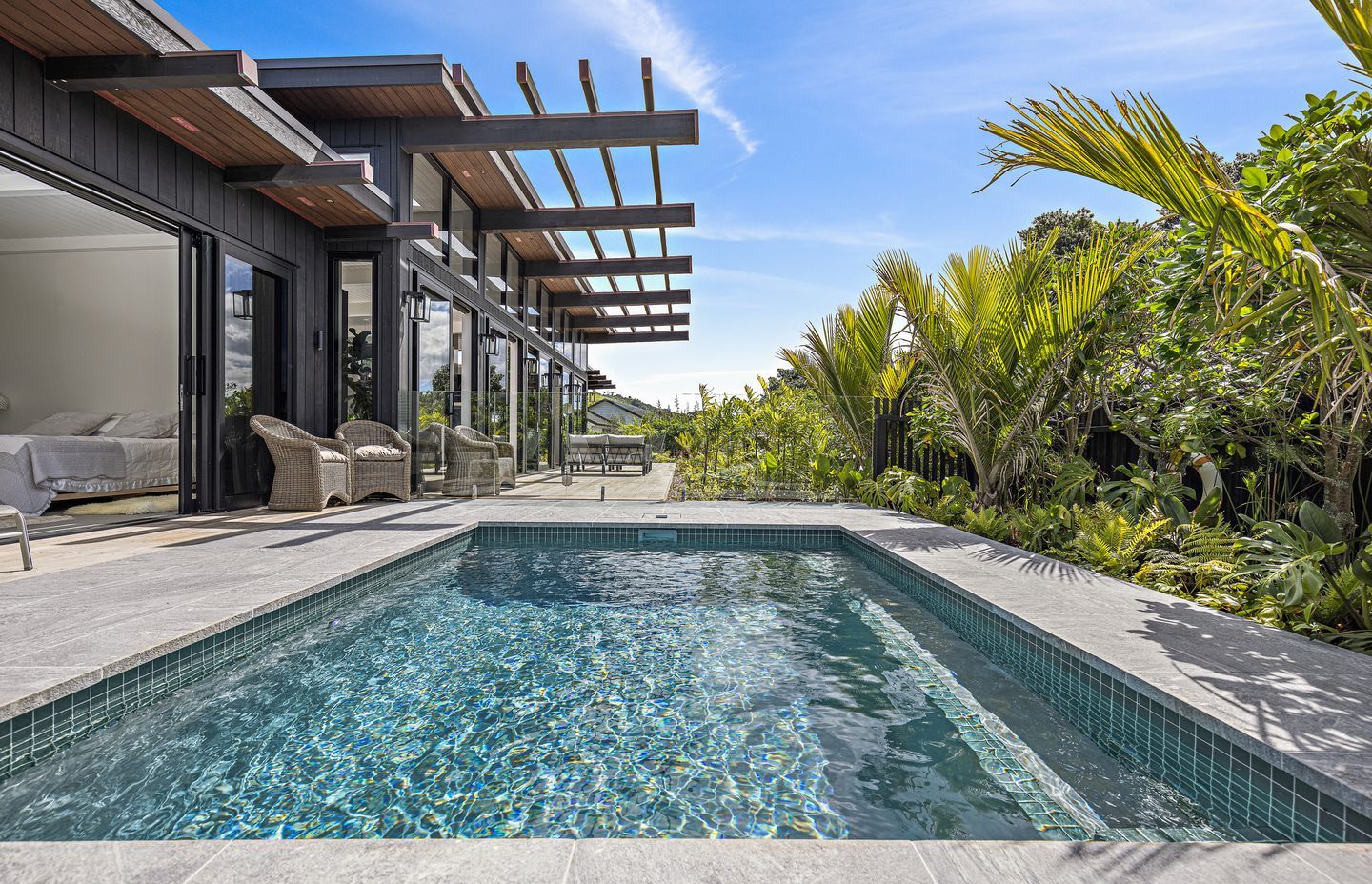 The pool can be directly accessed from the master bedroom, and is accessible from the living area via the connecting deck. Built by Matakana Pools.