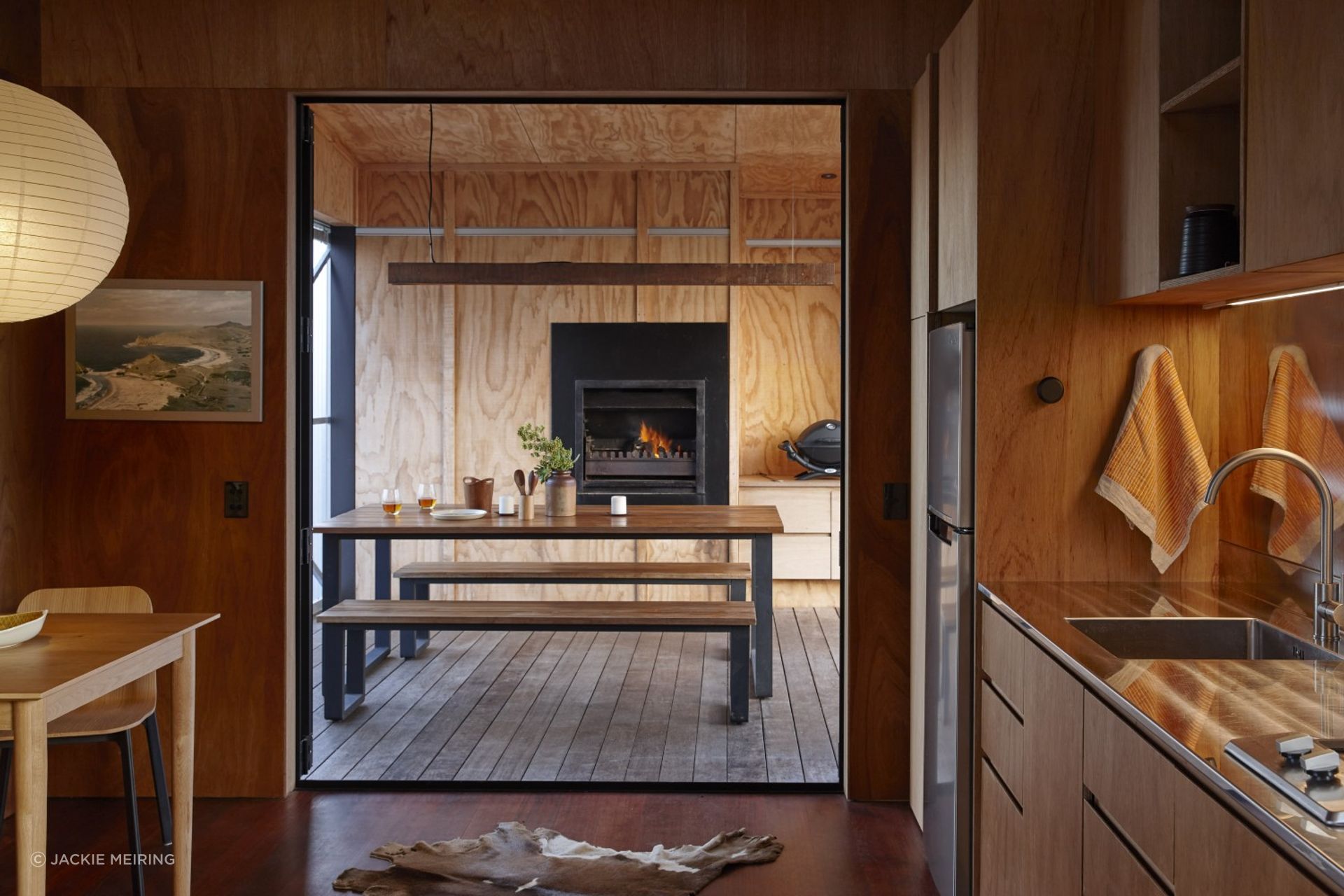 The living space opens onto a centrally located deck with an open fire and barbecue.